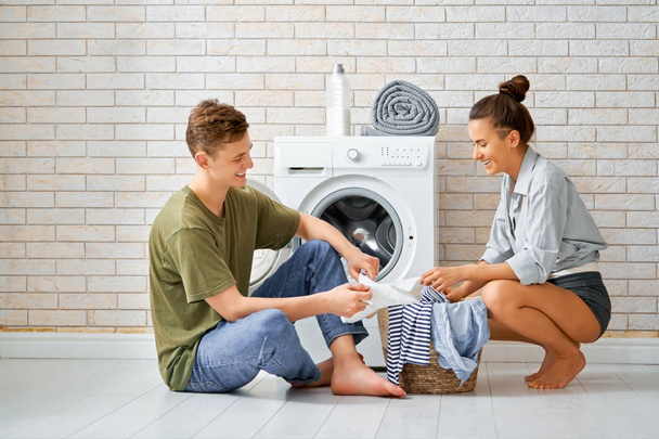 loving couple is doing laundry - Φωτογραφία, εικόνα