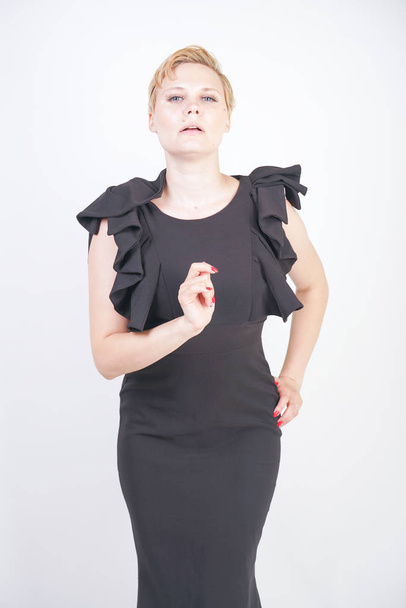 Portrait de jolie jeune femme joufflue en robe noire serrée
 - Photo, image