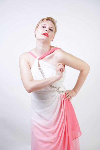 portrait of short-haired plump woman in pink evening dress - 写真・画像