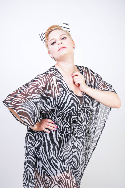 attractive pretty woman wearing zebra dress in studio - Фото, изображение