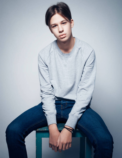 Attractive teenage boy posing in studio - Foto, Imagen