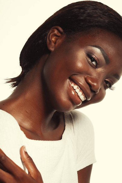 lifestyle and people concept:  Portrait of a beautiful young African woman smiling. - 写真・画像