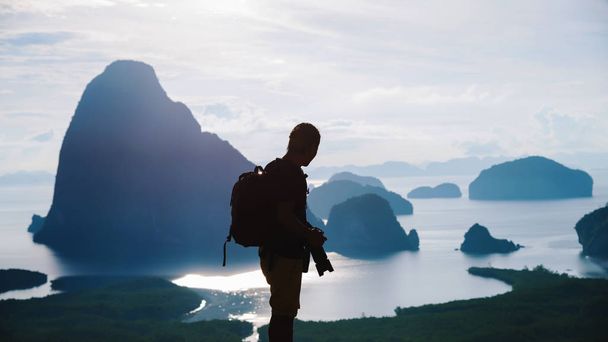 Men travel photography on the Mountain. Tourist on summer holiday vacation. Landscape Beautiful Mountain on sea at Samet Nangshe Viewpoint. Phang Nga Bay , Travel Thailand, Travel adventure nature. - Photo, Image