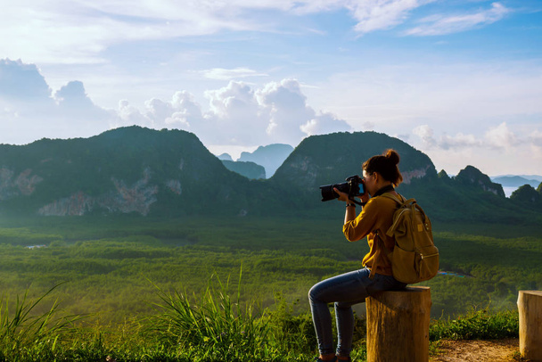 Young woman travels to take pictures of nature on the mountain. Travel adventure. Landscape Beautiful Mountain on sea at Samet Nangshe Viewpoint. Phang Nga Bay, Travel Thailand, summer holiday. - Photo, Image