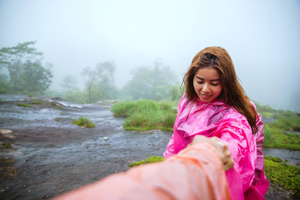 tourist with pink rain coat walking travel adventure nature in the rain forest. travel nature, Travel relax, Travel Thailand, rainy season. - Photo, Image