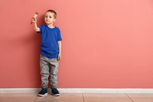 Little boy with brush near color wall - Foto, Imagen