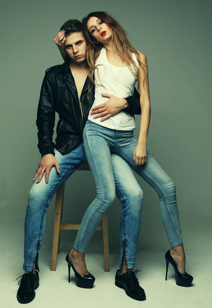 beautiful young half-dressed couple hugging, passion and tenderness, fashionable concept over grey background - Photo, image