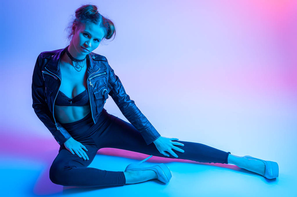 Beauty Rainbow pink and blue  woman silhouette. Neon profile portrait of young woman  in  a black leather jacket, underwear and pants.Design Art concept. Creative Colorful neon Portrait .  - Photo, image