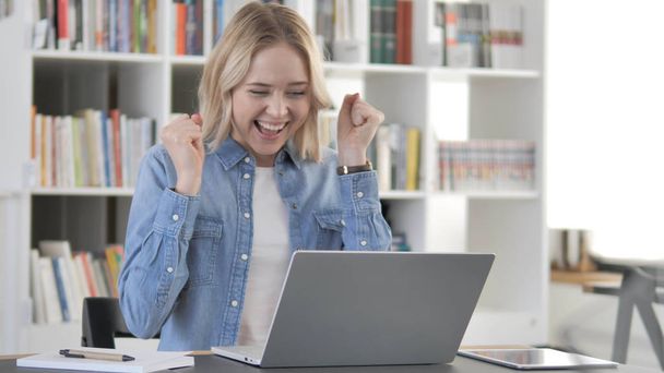 Excited Young Blonde Woman Celebrating Success at Work - Фото, зображення