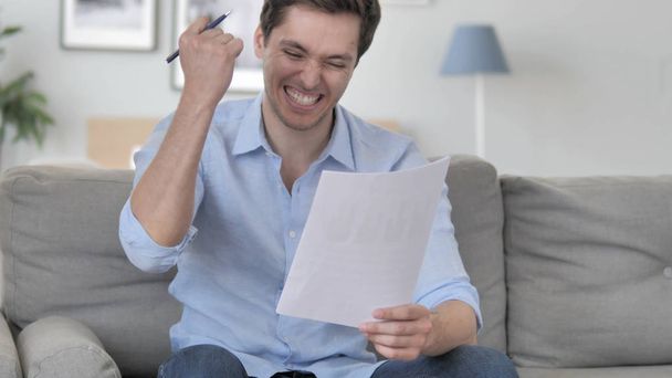 Excited Handsome Young Man Cheering while Reading New Contract - Photo, Image