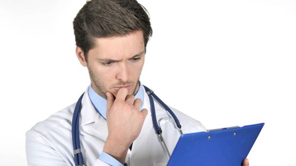 Pensive Doctor Reading medical Documents Isolated on White Background - Foto, Imagem