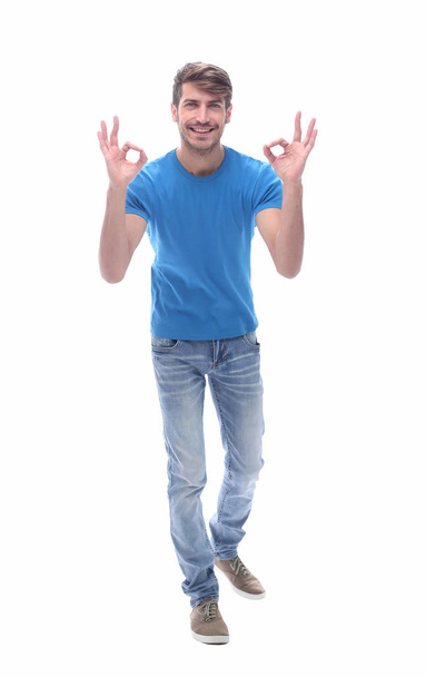 smiling modern guy showing OK gesture. isolated on white - Foto, afbeelding