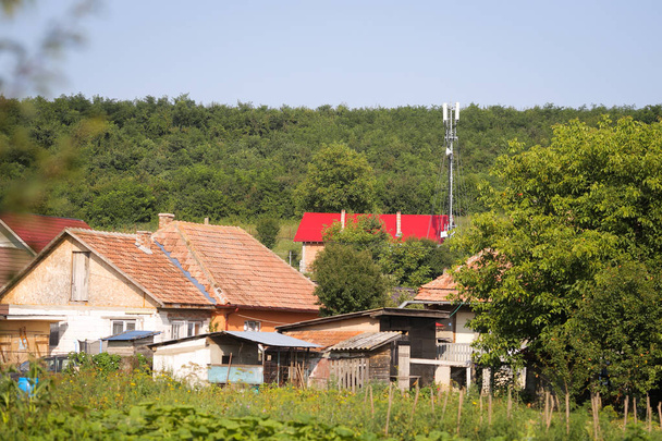 4G and 5G antennas in a village, between houses and heavy vegeta - Photo, Image