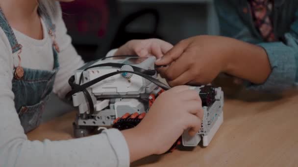 Mixed Racial group of School kids sitting at class with diy robot, stem education concept. - Footage, Video