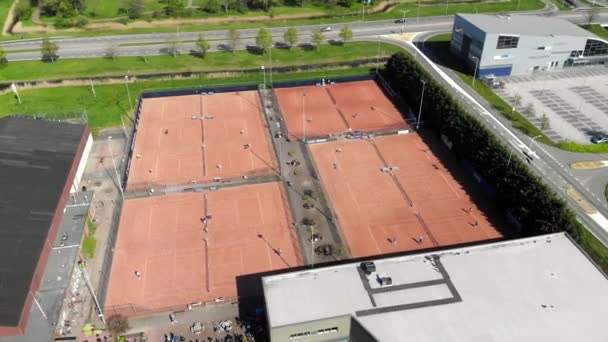Aerial view tennis courts and athletes who conduct a game of tennis. Tennis courts with people who play tennis. - Footage, Video