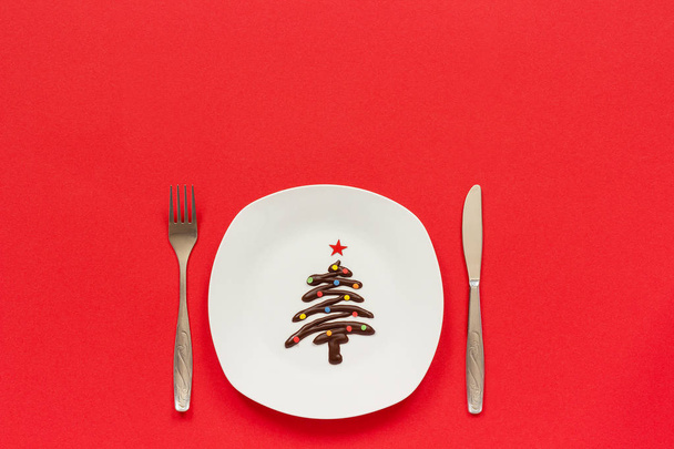 Sweet chocolate Christmas tree on plate and cutlery - Photo, Image