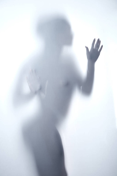 nude poor woman trying to leave the room - 写真・画像
