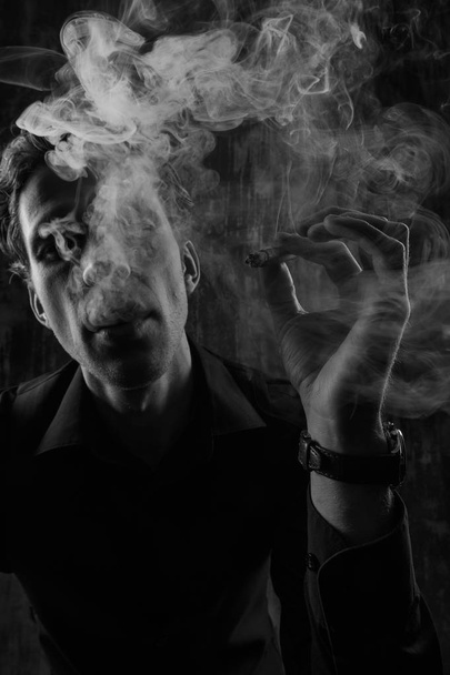 Brutal Mystery man with cigar and smoke isolated on black background - Foto, immagini