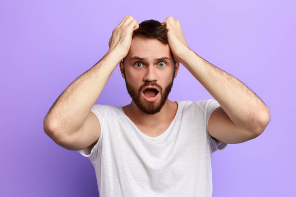 Man tears his hair, expresses negative feeling and emotion - Фото, зображення