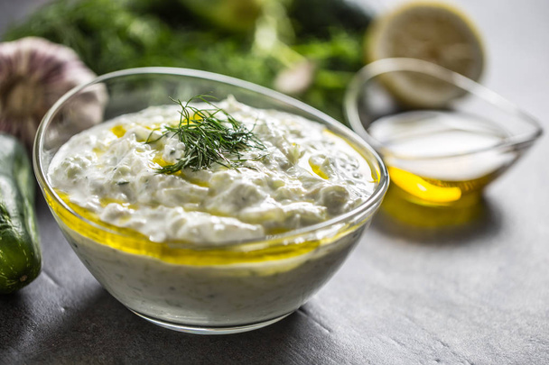 Tzatziki sause in a glass bowl dill cucumber olive oil lemon and garlic - Zdjęcie, obraz