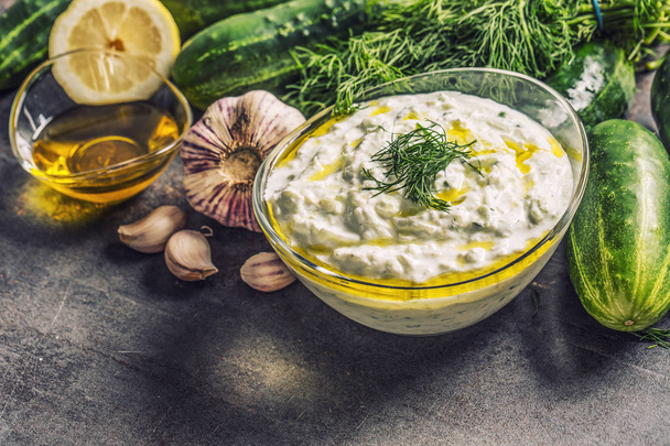 Tzatziki sause in a glass bowl dill cucumber olive oil lemon and garlic - Фото, изображение