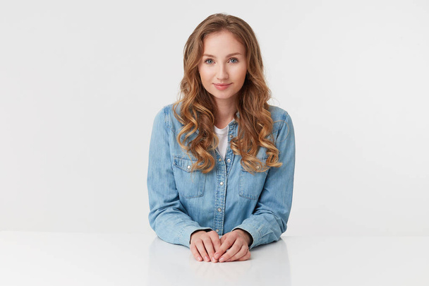 Portrait of young cute curly blonde lady in denim shirts sitting - Photo, Image