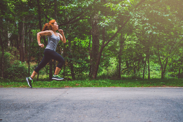 Les femmes s'entraînent dans la rue. Parc naturel. Une fille qui soulève les jambes pour faire de l'exercice. exercice, courir, Fille qui court jogging
. - Photo, image