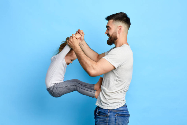 happy awesome dad doing exercises with daughter - Photo, image