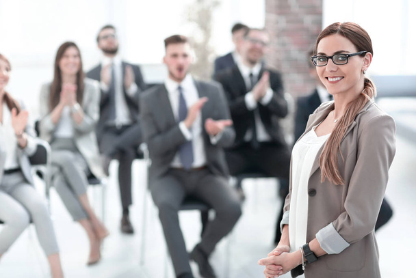 business woman on blurred background of listeners in conference room - Photo, Image