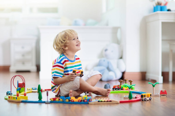 Kids play wooden railway. Child with toy train. - Photo, Image