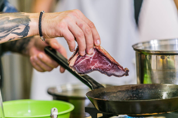 Grilling steak on grill pan. Beefsteak cooking on a kitchen. Fresh, delicious meat  - Φωτογραφία, εικόνα