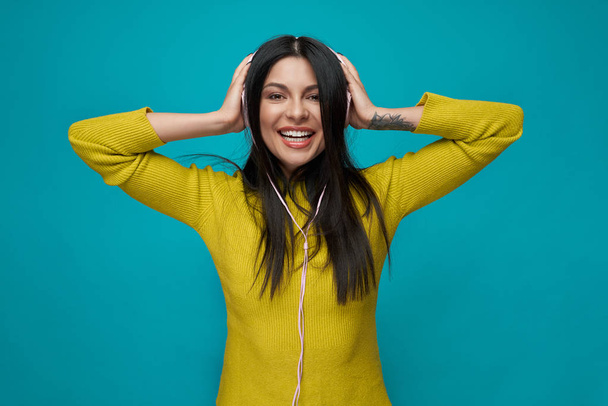 Charming model listening music with headphones, smiling. - Фото, зображення