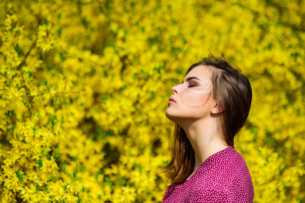 fashion beauty. summer blooming trees and yellow flowers. sexy woman in spring blossom. natural beauty makeup. hair fashion. pretty woman skincare. girl like nature. Sensuality - Foto, afbeelding