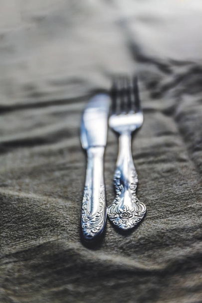 retro vintage cutlery knife and fork on antique tablecloth - Photo, Image