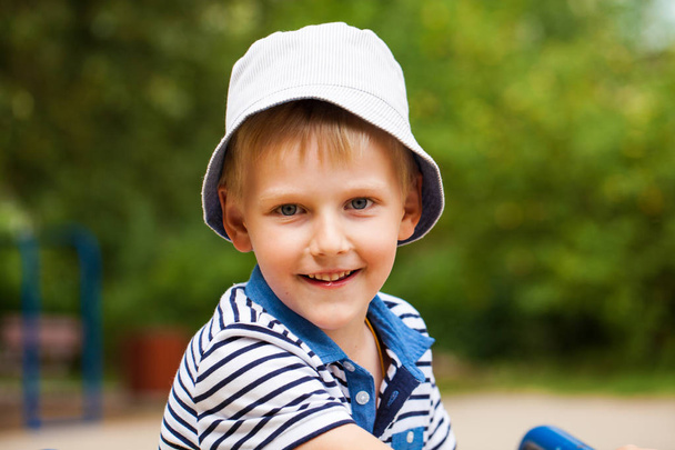 Portrait of a little blonde boy in a blue hat - Zdjęcie, obraz
