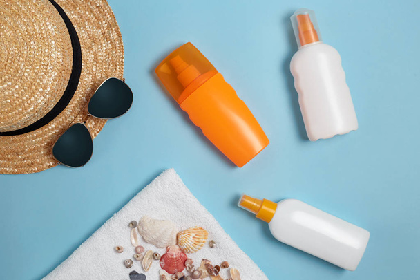 Beach flat lay accessories. Sun hat,  towel,cream, sunscreen bottle, sun cream, lotion bottle, seashells . Summer travel holiday concept - Fotó, kép