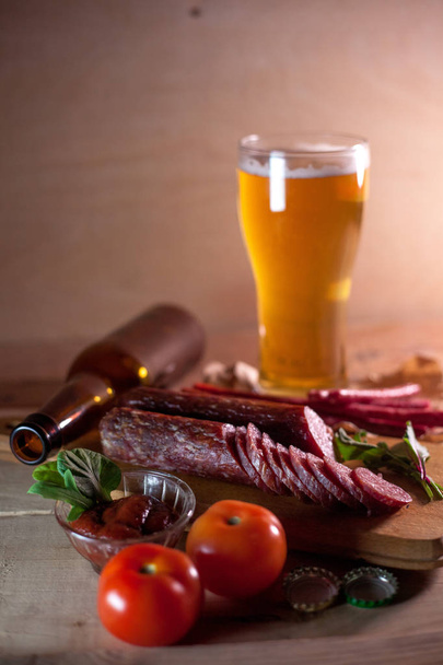 Sausages with tomatoes, light beer and a bottle - Photo, image