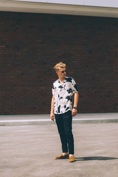 Photo of trendy young man walking on street  - Foto, Bild