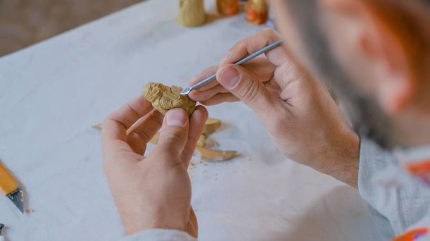 Potter making clay figure for board game - Photo, Image