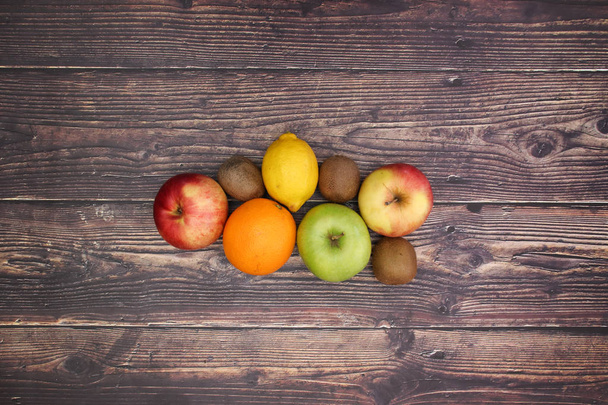 Fresh and healthy fruit on the wooden background - Foto, Imagen