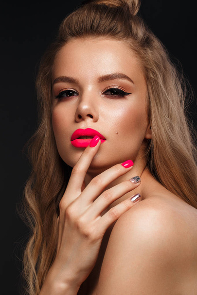 Beautiful young woman with bright makeup and neon pink nails. Beauty face. Photo taken in the studio - Fotoğraf, Görsel