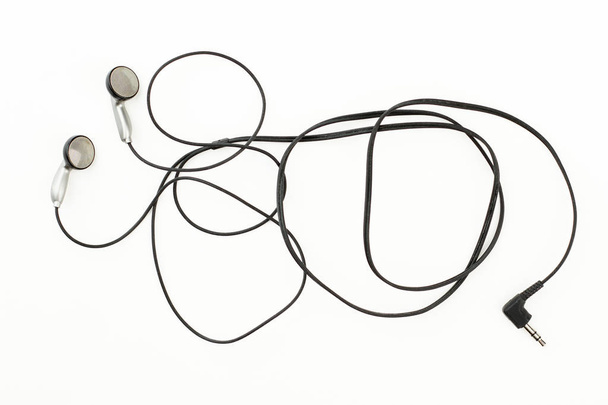 Grey earbuds over white background. - Photo, Image