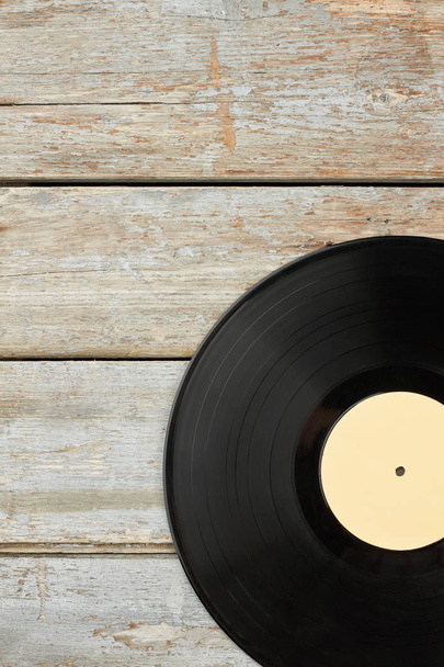 Vinyl record on old wooden background. - Photo, Image