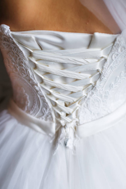 die Braut in einem wunderschönen weißen Kleid und Korsett mit Schleife. b - Foto, Bild