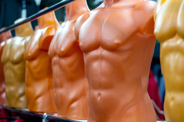 Many different plastic naked male mannequins in the clothing shop - Photo, Image