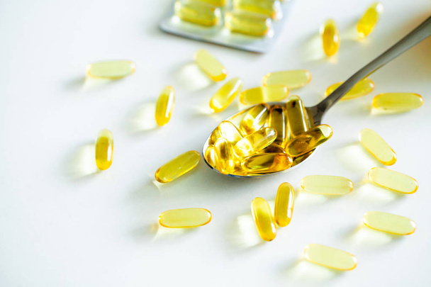 Vitamins supplements, fish oil in yellow capsules omega 3. - Photo, Image