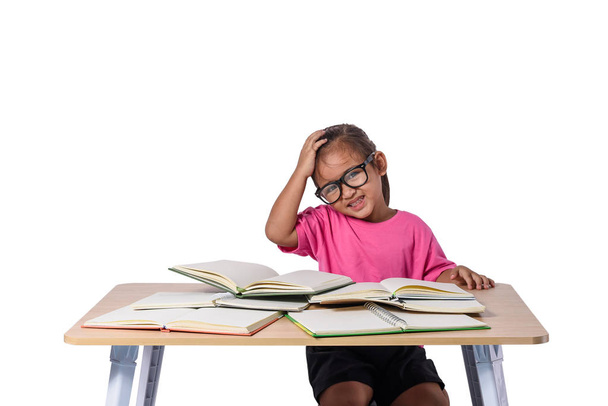 little girl with glasses thought and many book on the table. bac - Fotoğraf, Görsel