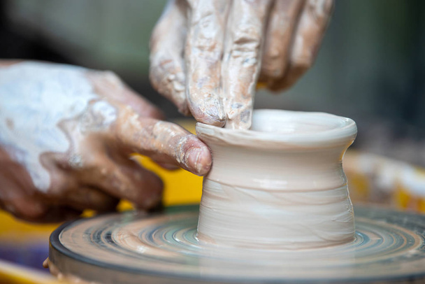 Potter makes pottery dishes on potter's wheel - Photo, Image