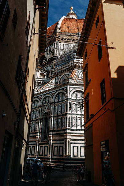 The famous Basilica Church of Santa Maria del Fiore view from a narrow street | FLORENCE, ITALY - 14 SEPTEMBER 2018. - Fotó, kép