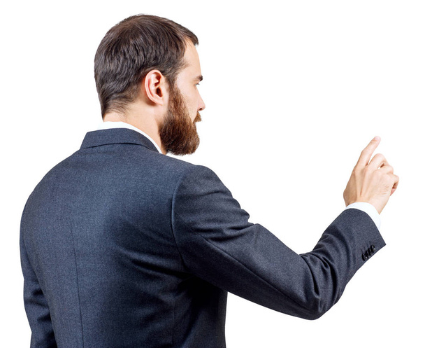 Biznesmen z brodą wskazując na coś lub dotykając przez palec wskazujący. - Zdjęcie, obraz